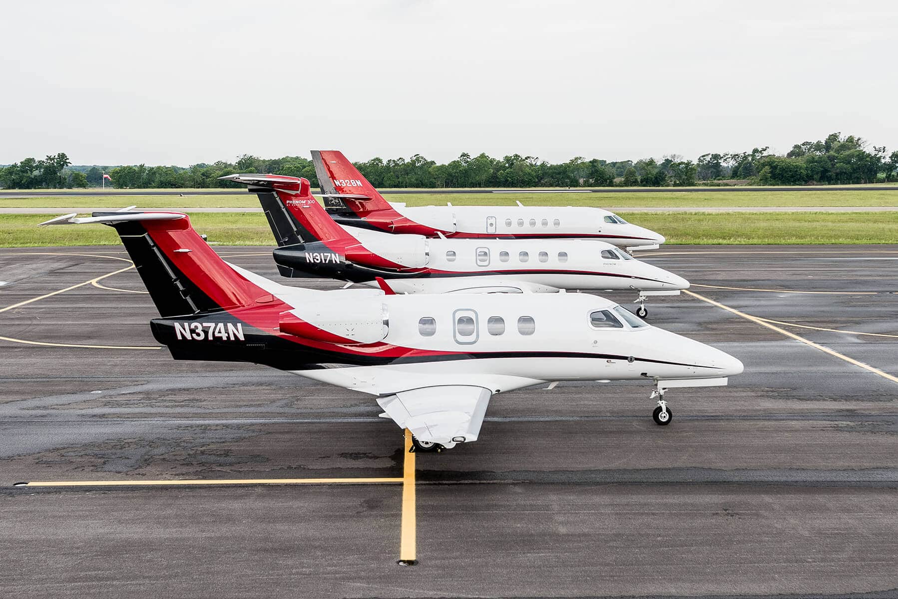 Embraer Phenom 100, Embraer Phenom 300, and Cessna Citation Latitude on Tarmac