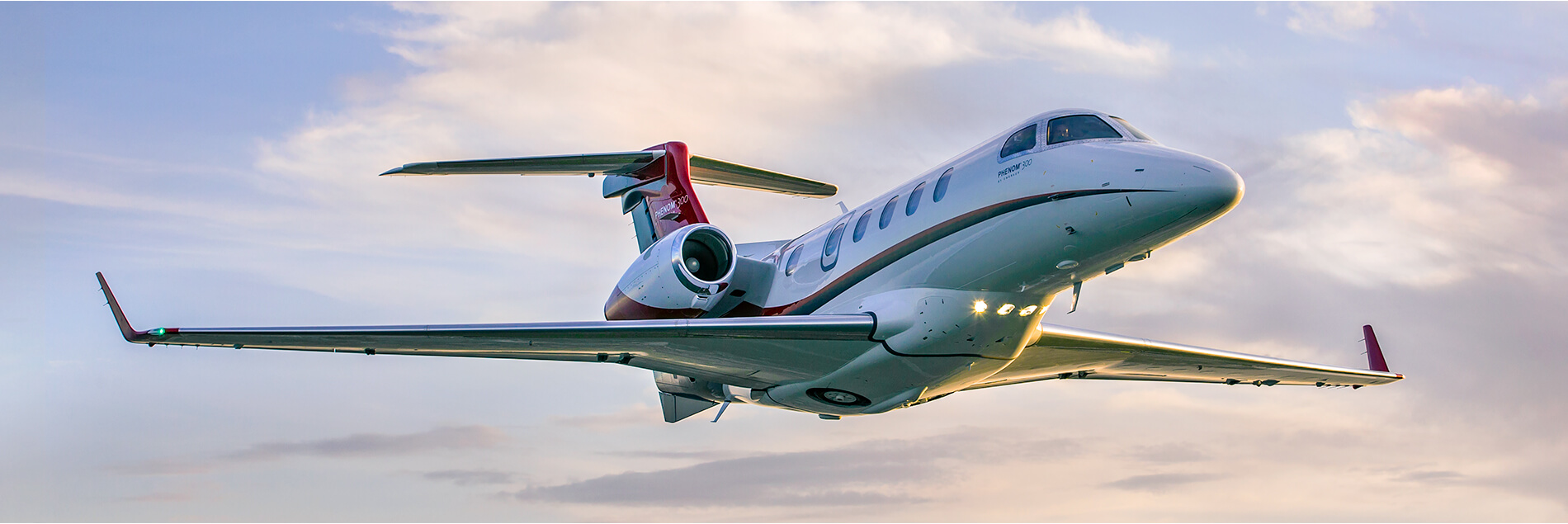 Phenom 300 Aerial Against Pink & Blue Sky