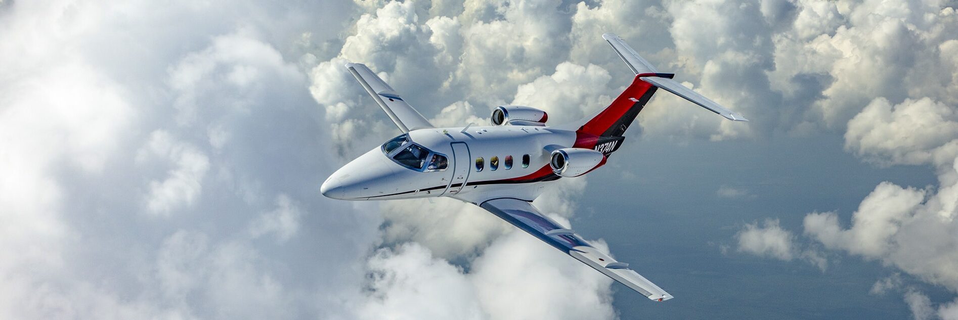 Embraer Phenom 100 Aerial White Clouds