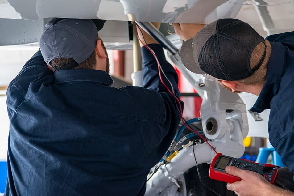 NICHOLAS AIR Maintenance techs working on an aircraft